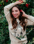 Woman in ivory Paddington Bear sweater