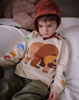 kids knit pullover with Brown Bear design, embroidered story animals on sleeves, shoulder buttons