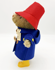 Paddington soft toy, 10 inches tall, side view, wearing a red hat, blue coat, and yellow boots.