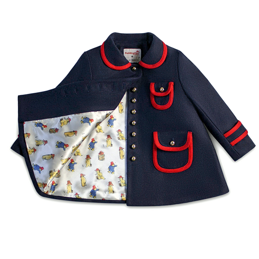 Navy blue coat with red trim, gold buttons, and a Paddington print lining