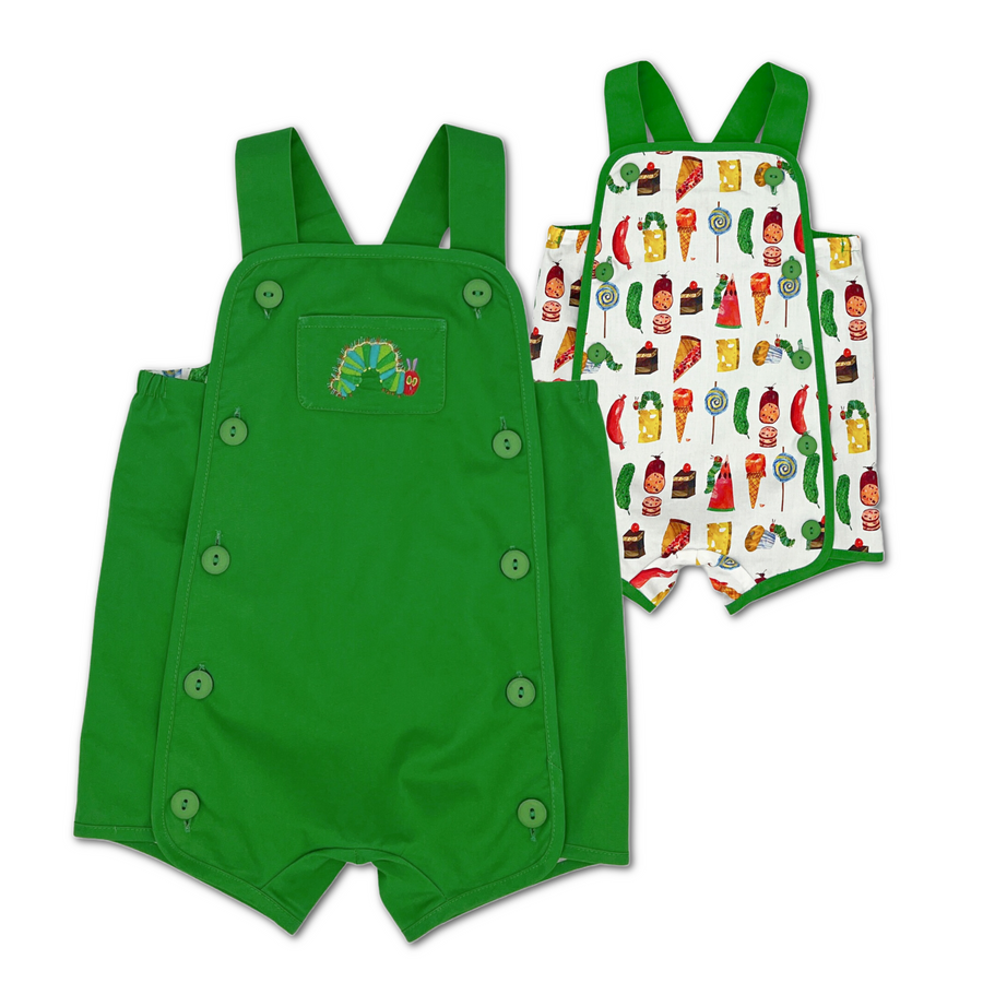 Reversible baby romper with a green side featuring buttons and an embroidered caterpillar, and a white side with colorful food prints