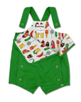 playful lining of vibrant green baby romper with adjustable shoulder straps and side button closures. The inner lining features a colorful food-themed print inspired by Eric Carle, displaying various illustration.