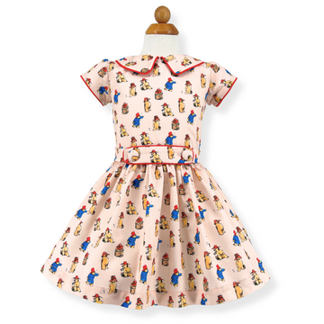 Children's Paddington Bear print dress with red piping and belt.