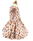 Side view of a pink Paddington Bear dress with red piping