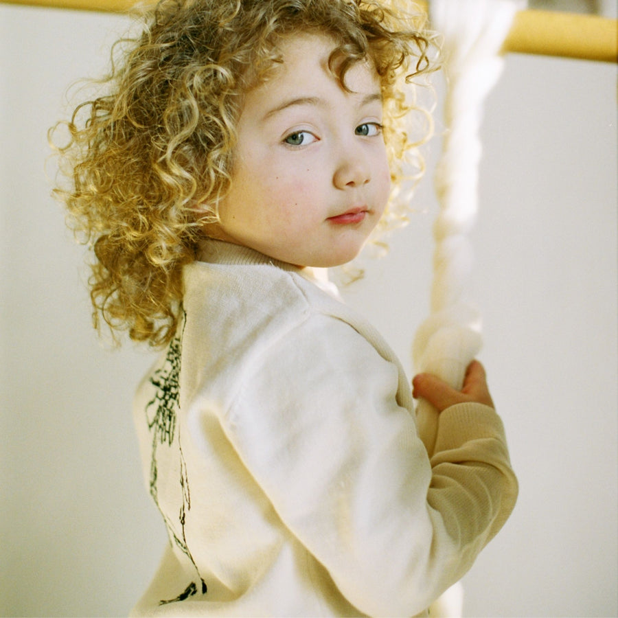 Child wearing a Paddington bear sweater.