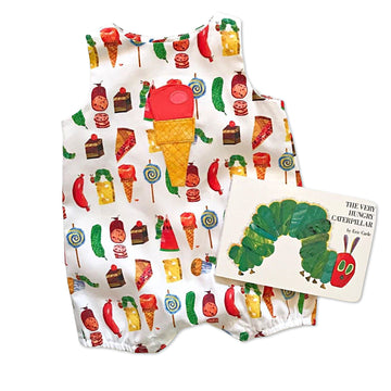 children's sleeveless romper featuring a colorful print of various foods inspired by The Very Hungry Caterpillar by Eric Carle. Romper has an appliqué of an ice cream cone with a red scoop. A copy of The Very Hungry Caterpillar book is placed beside the outfit