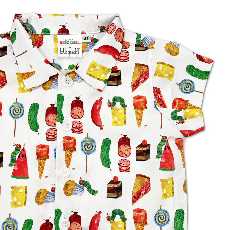 Children's short-sleeve button-up shirt featuring a colorful print of various foods, including cheese, ice cream, lollipops, watermelon, and cake, along with the green caterpillar from The Very Hungry Caterpillar by Eric Carle